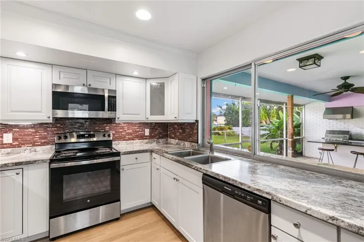 Kitchen with pass through sliding window to outdoor kitchen