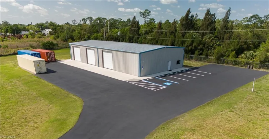 View of outdoor structure with a garage and a yard