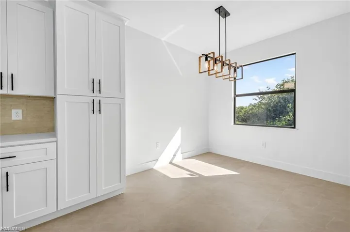 Unfurnished living room with a tray ceiling, ceiling fan, dark wood-style floors, and recessed lighting