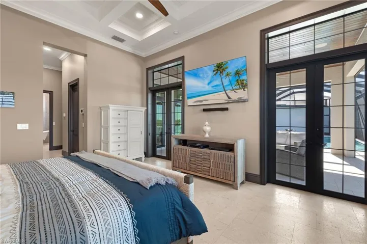 Master Bedroom with coffered ceiling, crown molding, beamed ceiling, and french doors