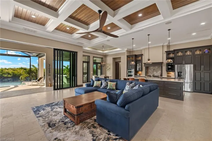 Living room featuring wooden ceiling, beam ceiling, ornamental molding, and coffered ceiling