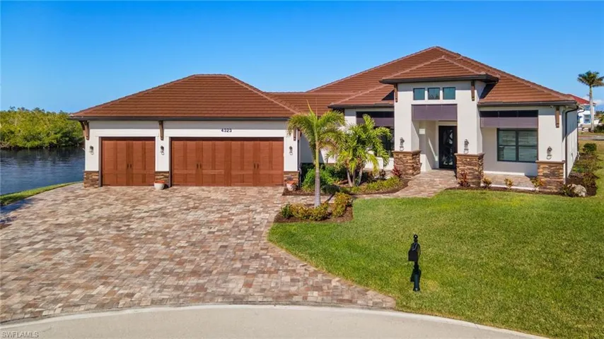 View of front facade with a front yard and a water view