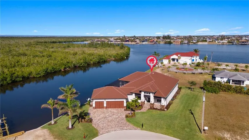 Birds eye view of property with a water view