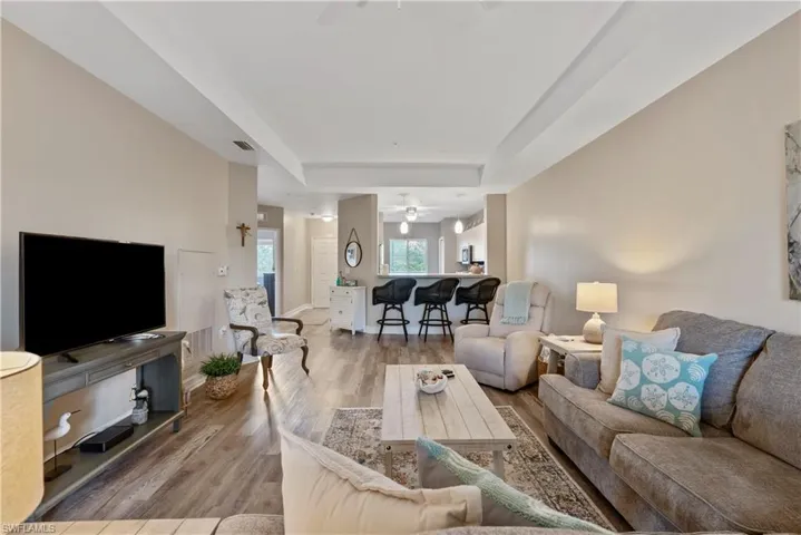 Living room featuring ceiling fan and light wood-type flooring