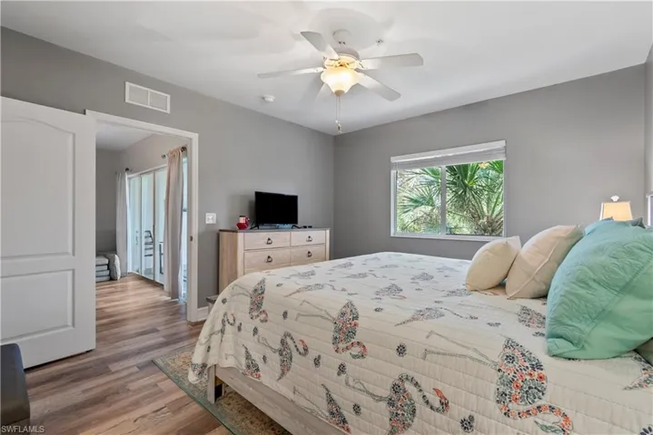 Bedroom with ceiling fan and wood-type flooring