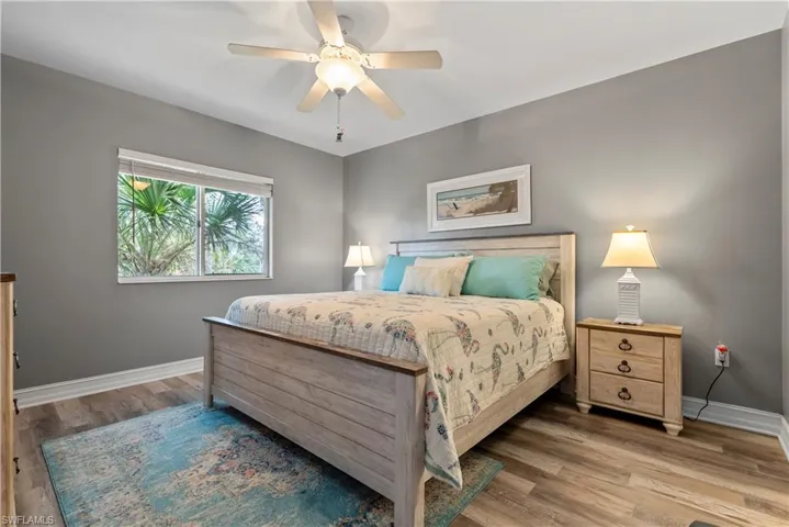 Bedroom with hardwood / wood-style flooring and ceiling fan