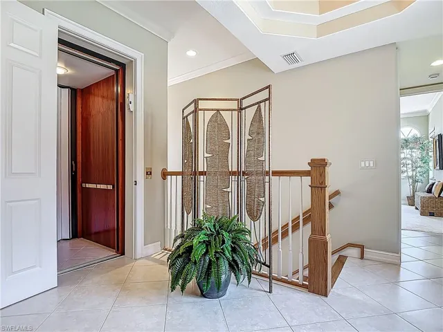 Hallway featuring crown molding, light tile patterned flooring, recessed lighting, and baseboards