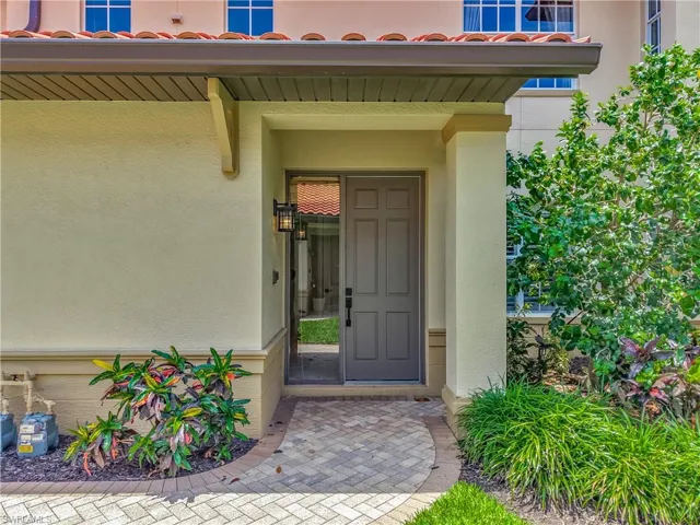 Property entrance featuring stucco siding and a tile roof