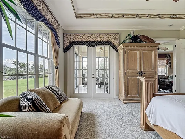 Bedroom featuring french doors, access to outside, light colored carpet, and ornamental molding