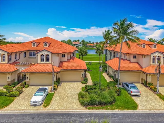 Mediterranean / spanish-style home featuring a tiled roof, stucco siding, decorative driveway, and a residential view