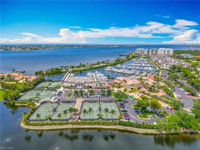 Aerial view of property and surrounding area with a large body of water