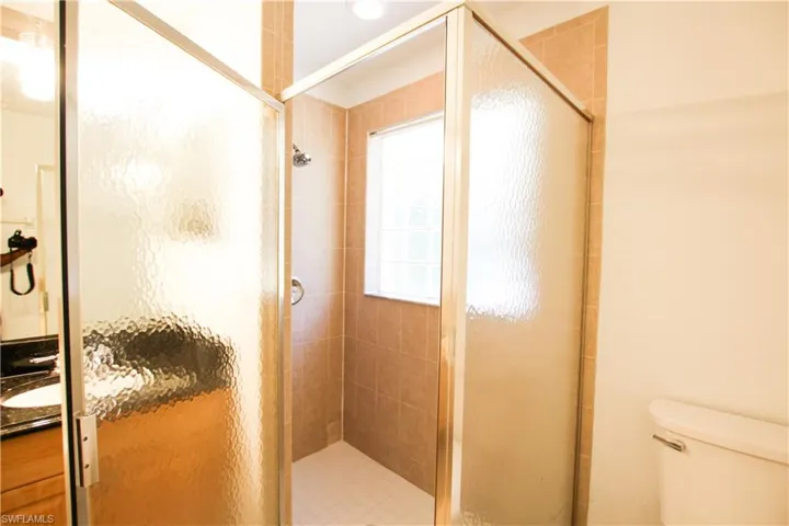 Full bathroom with a shower stall and vanity