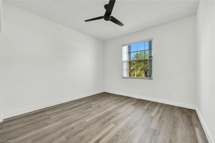 Second bedroom featuring light laminate wood floors and ceiling fan