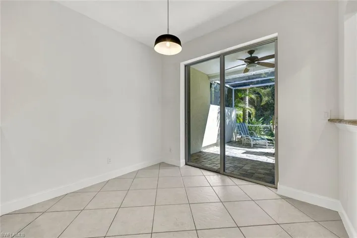 Breakfast/Dining area with light tile floor floors, and view of the screened in Lanai & Patio