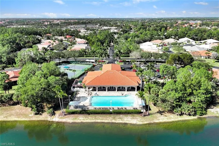 Bird's eye view of the community pool and club house with views of the lake