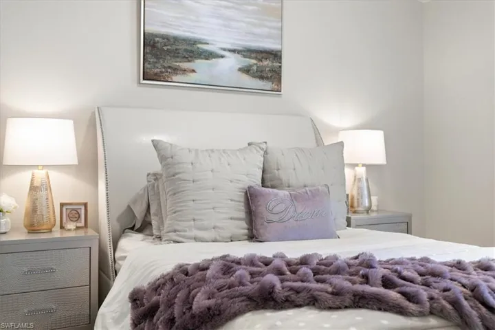 Bedroom with vaulted ceiling, LVT floors, and ceiling fan
