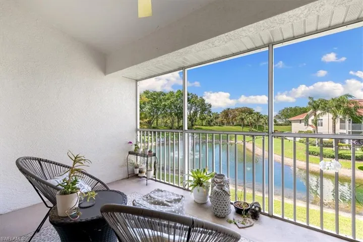 Sunroom with a textured wall and a water view