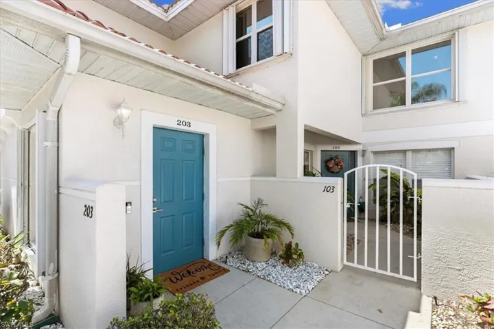 Entrance to property featuring a tile roof, stucco siding, and interior entry way