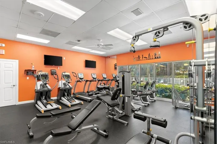 Gym featuring multiple cardio and weight equipment