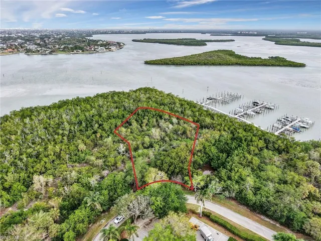 View of property location with property parcel outlined, a marina, and a nearby body of water
