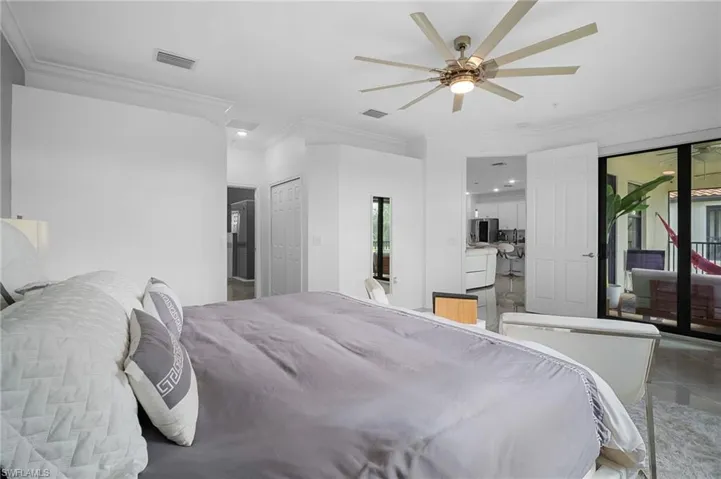 Spacious interior featuring crown molding, a multi-blade ceiling fan, recessed lighting, and tile flooring