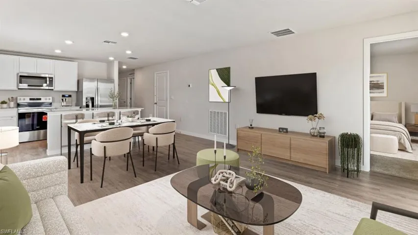 Open-concept living space featuring wood-finish flooring and recessed lighting