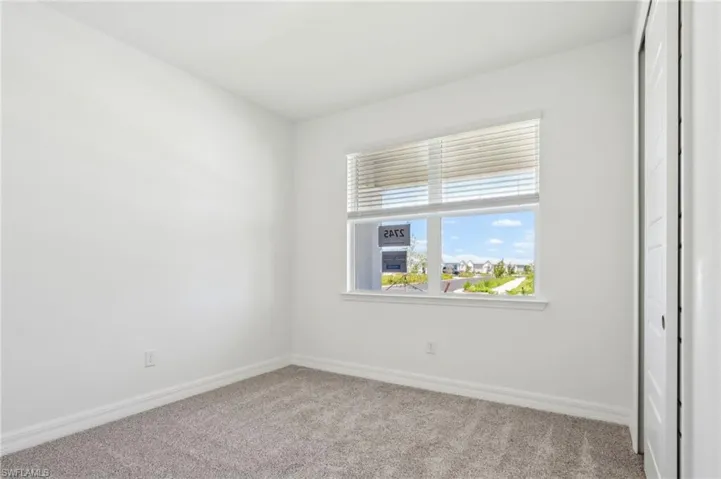 Unfurnished room with carpet and baseboards