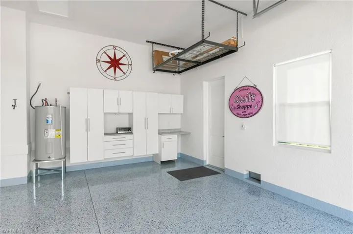 Beautiful garage with epoxy floors and extra high ceiling