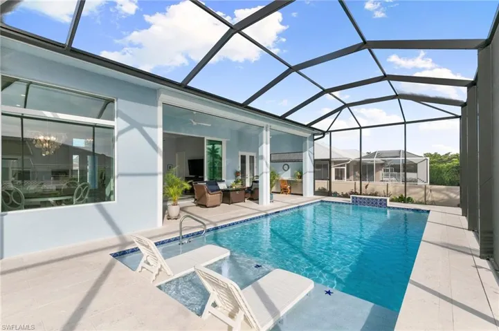 Pool with sun shelf, water feature, screened alanai