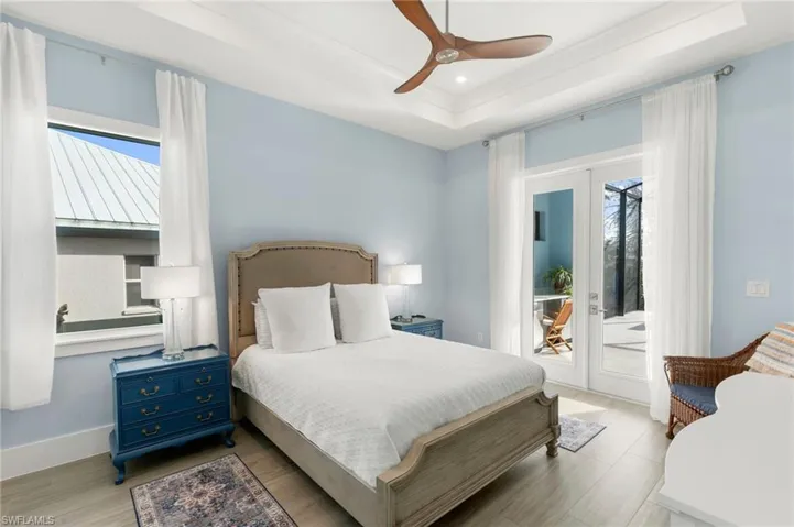 Primary bedroom with French doors to lanai in background