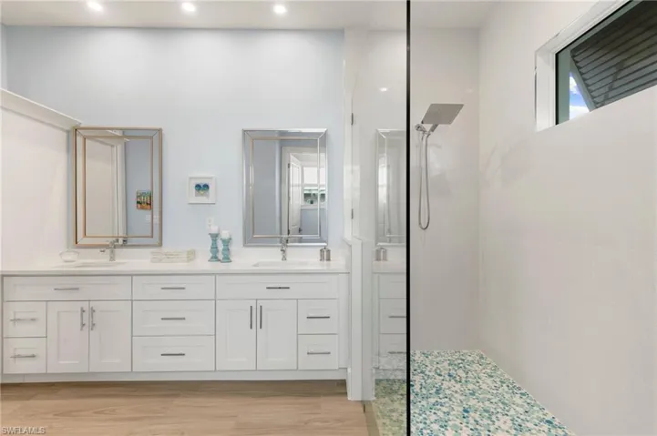 Primary bath with doorless glass walled walk in shower