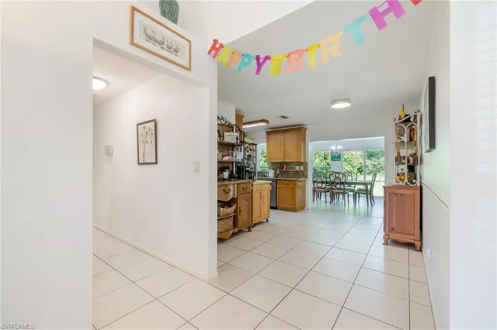 Kitchen with light tile patterned floors and brown cabinets