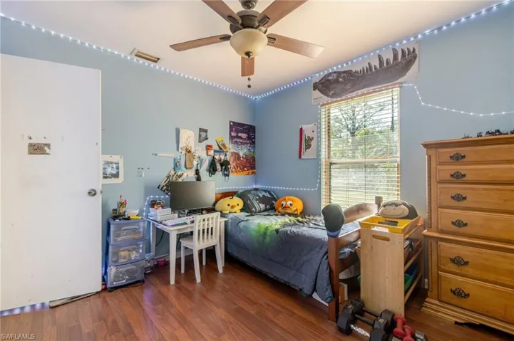 Bedroom featuring wood finished floors and a ceiling fan
