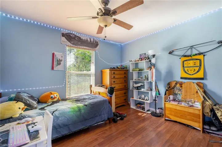 Bedroom featuring wood finished floors and ceiling fan