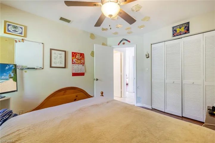 Bedroom with a ceiling fan and a closet