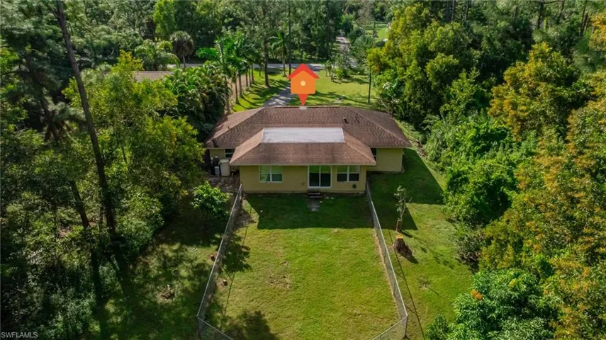 View from above of property featuring a tree filled landscape