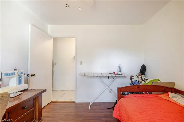 Bedroom featuring wood finished floors and baseboards