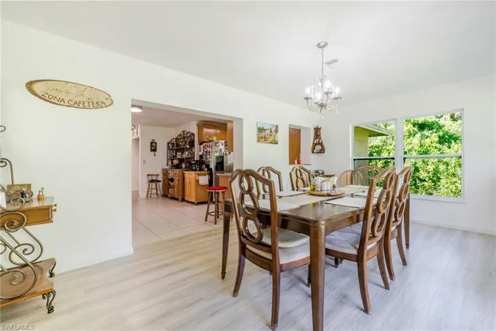 Dining space featuring wood finished floors and a chandelier
