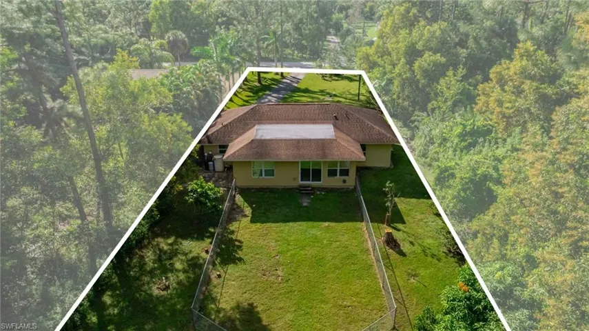 View of subject property with property parcel outlined and a tree filled landscape