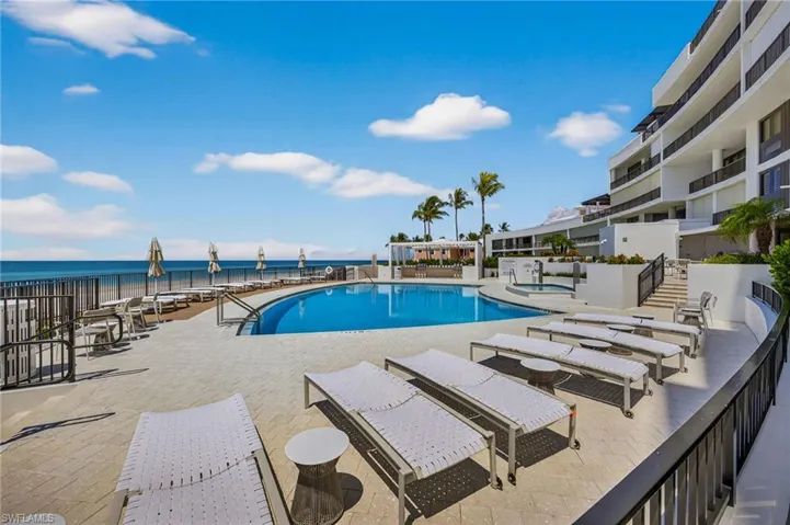 Community pool with a patio and a water view