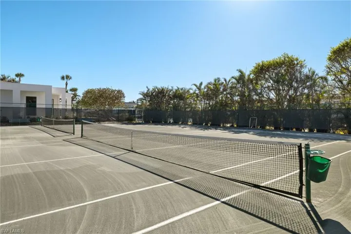 View of tennis court with community basketball court