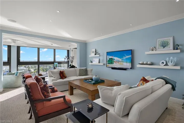 Living area with ornamental molding, carpet flooring, recessed lighting, and ceiling fan