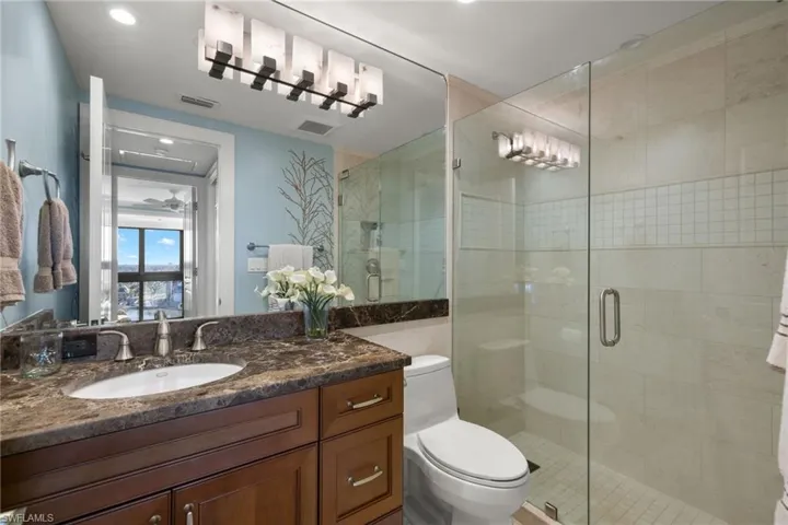 Full bathroom featuring a shower stall and vanity