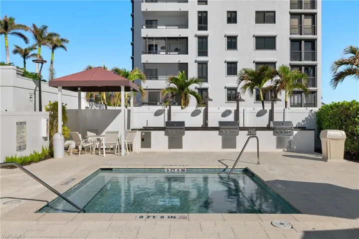 Community pool featuring exterior kitchen, a patio, and a gazebo