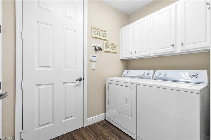 Large Laundry Room With Cabinets and Storage Closet