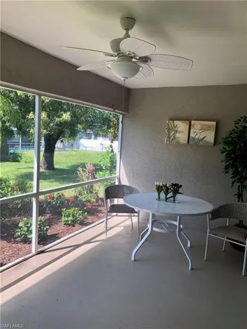 Sunroom featuring a ceiling fan