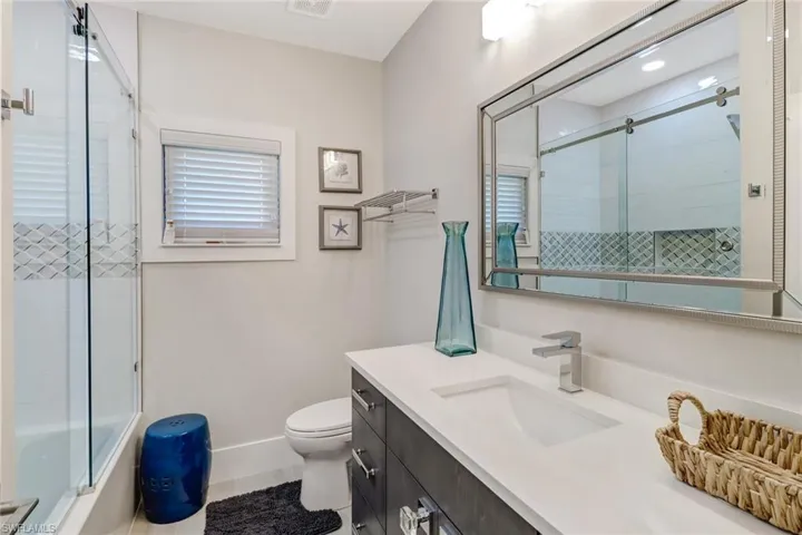 Full bath with vanity and enclosed tub / shower combo