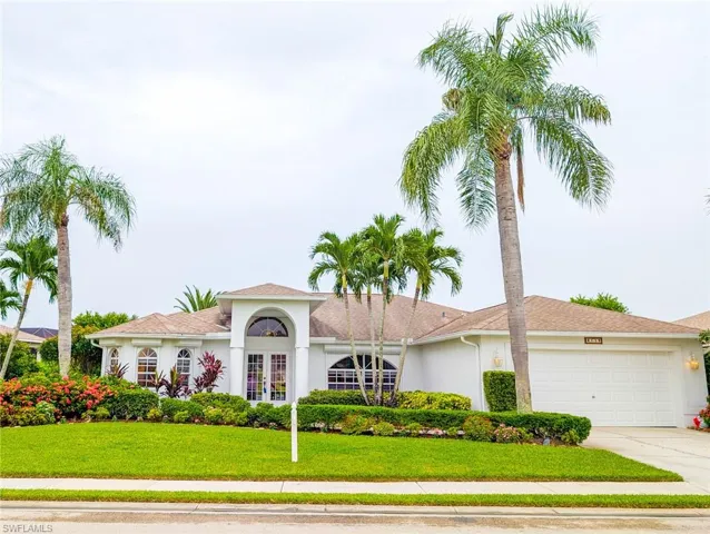 View of front of home featuring a garage and a front lawn