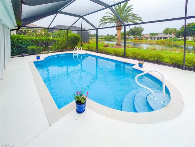 View of pool with a patio area and a lanai