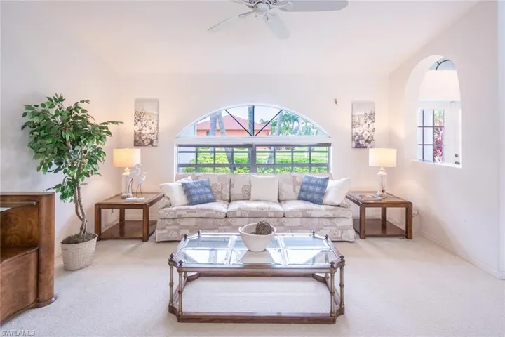 Living room with carpet flooring and ceiling fan